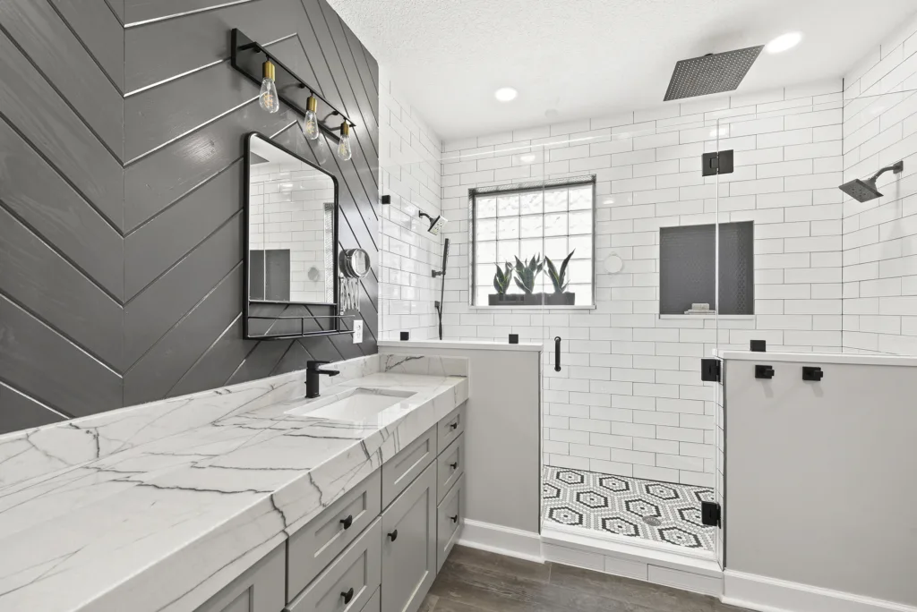 Blue tile walk-in shower with frameless glass in a Greystone bathroom