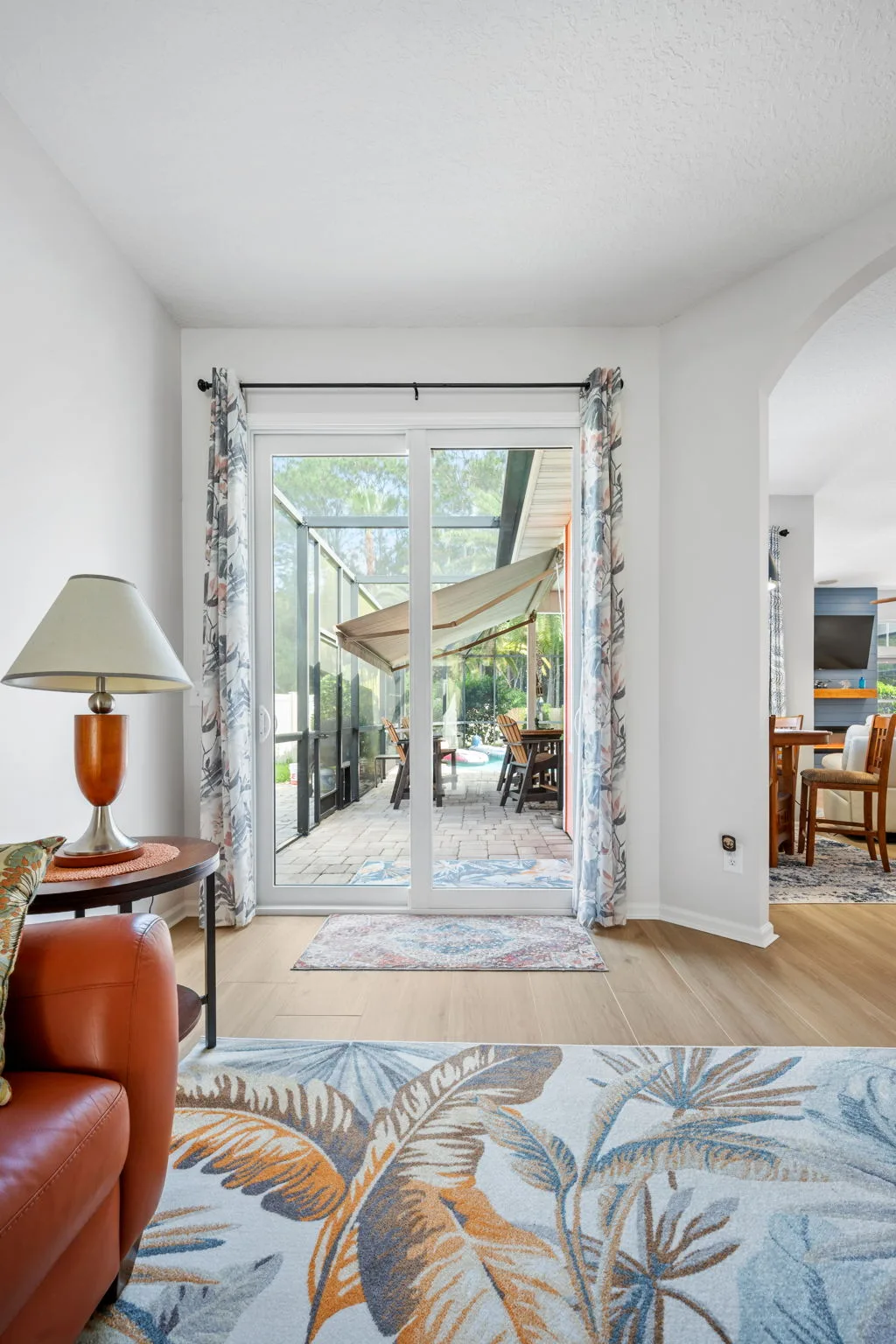 Arched transom windows above sliding glass doors