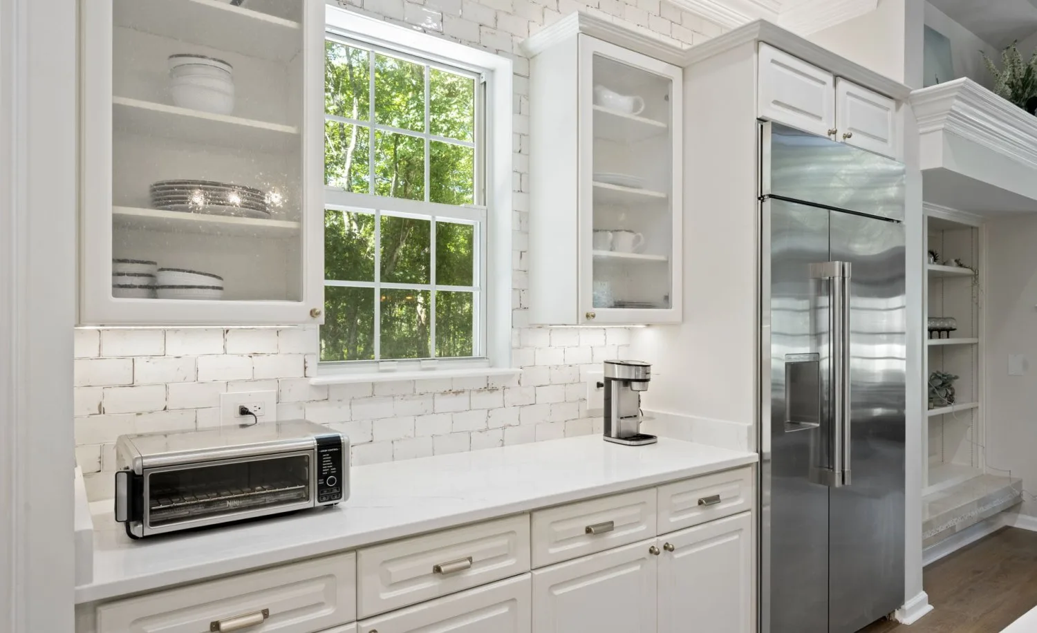 Same coffee bar after countertop replacement with white quartz and new hardware