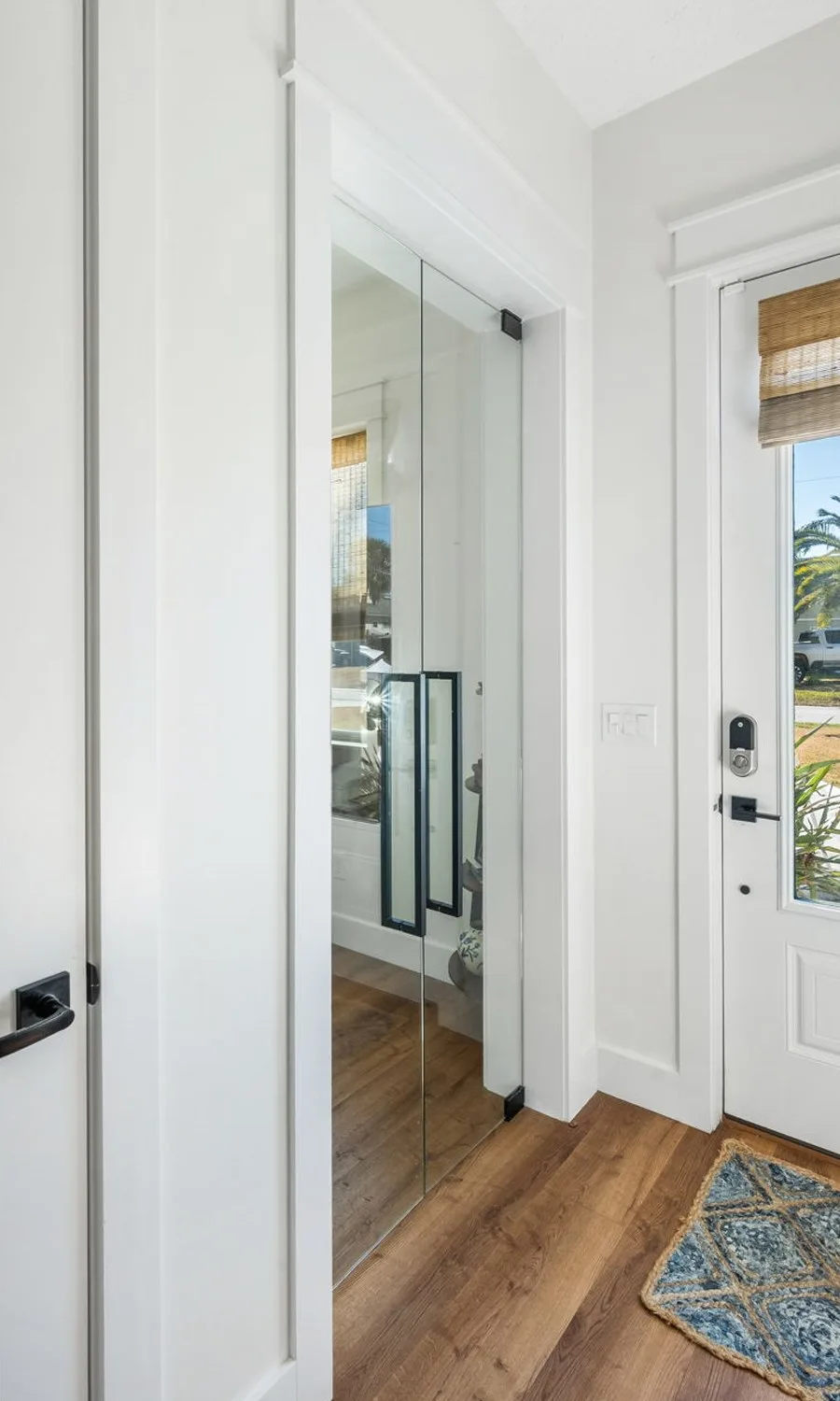 Entry after remodel with frameless glass double doors into the office and new trim
