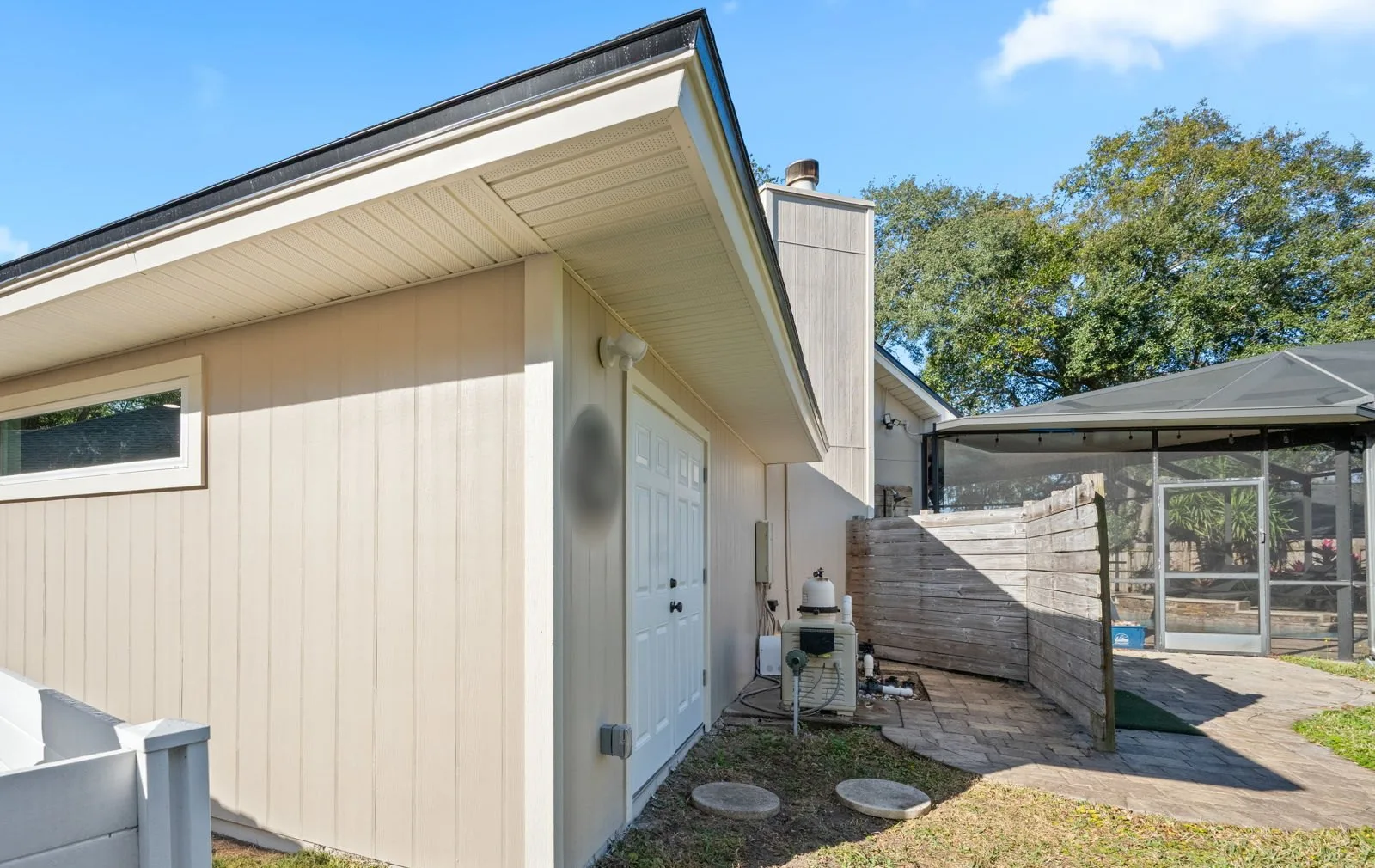 After: the rebuilt addition with new siding, roofline, window and double doors