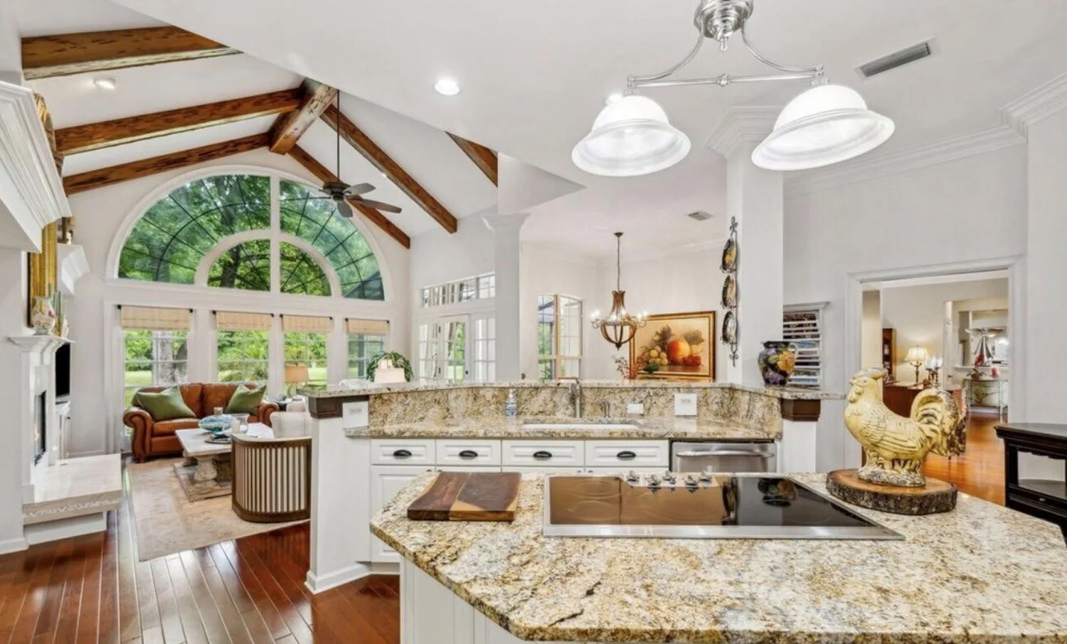 Vaulted kitchen before remodel with cherry hardwood floors and granite counters