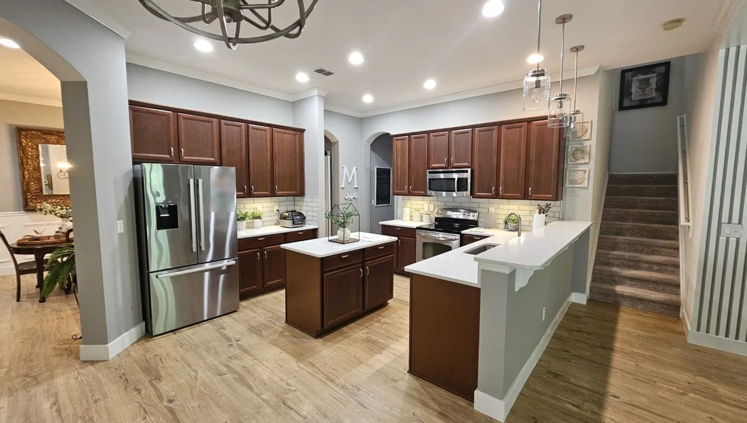 Kitchen before remodel with cherry cabinets, a small island and a raised peninsula