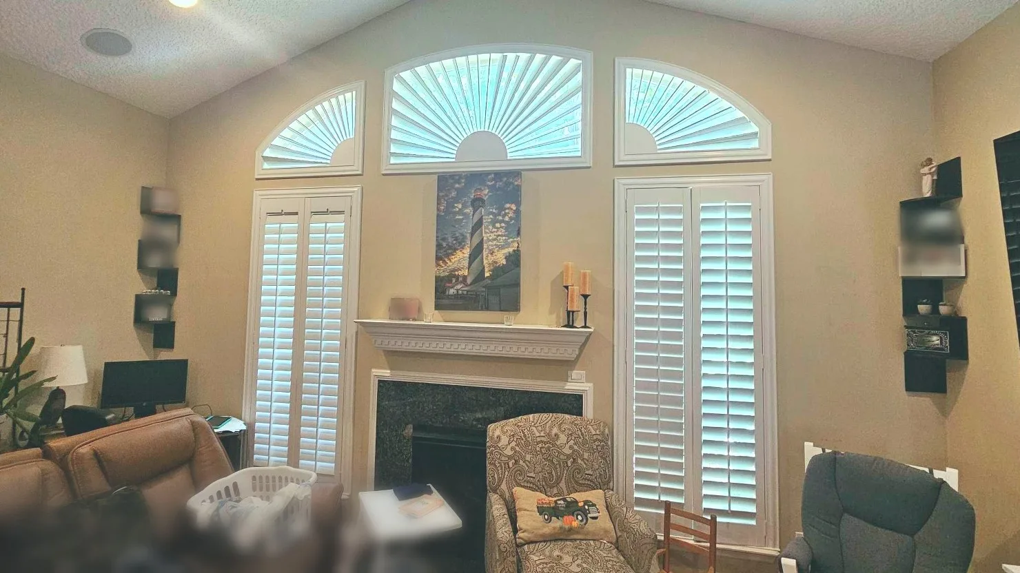 Before: shuttered windows flanking a fireplace beneath arched transoms